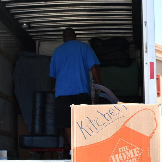 An employee of our Moving Company skillfully loads items into the back of a box truck, demonstrating our commitment to providing top-notch loading help for safe and secure local moving in Lexington and Louisville, KY.