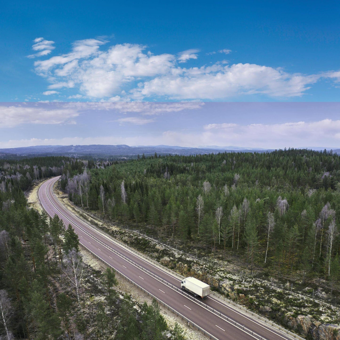 Aerial view of a Nomad Moving Company box truck on a long-distance journey, traveling down a highway, highlighting their reliable long-distance moving services in Lexington and Louisville, KY.