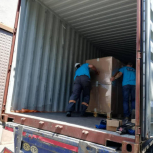 Two professional movers from Nomad Moving Company efficiently unloading belongings from a moving truck in Louisville, KY, demonstrating the company's commitment to providing top-notch unloading help services in both Lexington and Louisville, Kentucky.